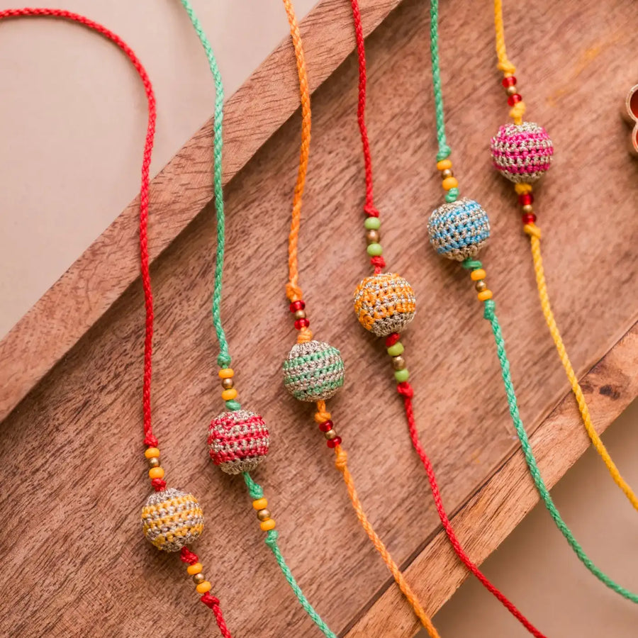 Handmade Crochet Multicolour Lined Suraj Rakhi With Roli Chawal Set Of 6 - Close-up of bead details