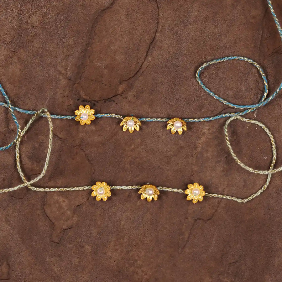Handmade Golden Flower Rakhi With Roli Chawal Set Of 2 - Flat Lay Front View