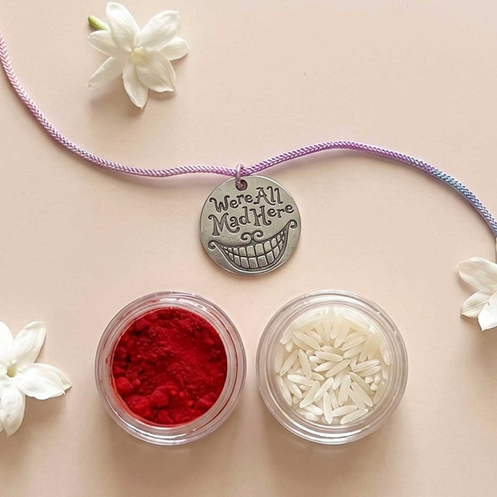 Engraved "We Are All Mad Here" Quote Metal Charm Rakhi With Roli Chawal for Brother