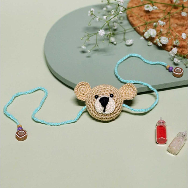 Handmade Crochet Teddy Hug Kids Lumba Rakhi With Roli Chawal - Front View with Accessories (4)