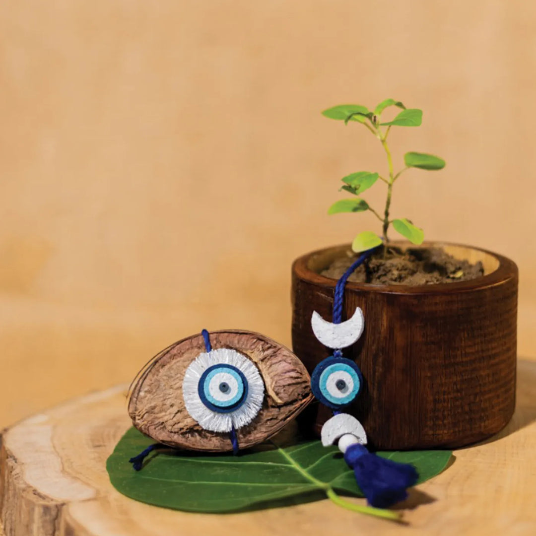 Nazarbattu Plantable Handmade Cork Rakhi Hamper With Roli Chawal - Rakhi placed by plant pot