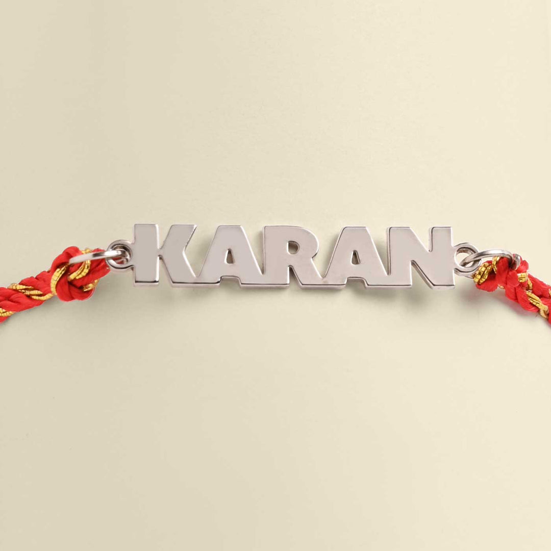 Personalized Handmade Bold Design Metal Rakhi - Front View of Name Bracelet KARAN