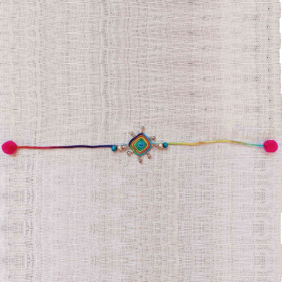 Handmade Dori Work Peacock And Ghungroo Bhaiya Bhabhi Rakhi With Roli Chawal Set Of 2 - Flat lay of full necklace length