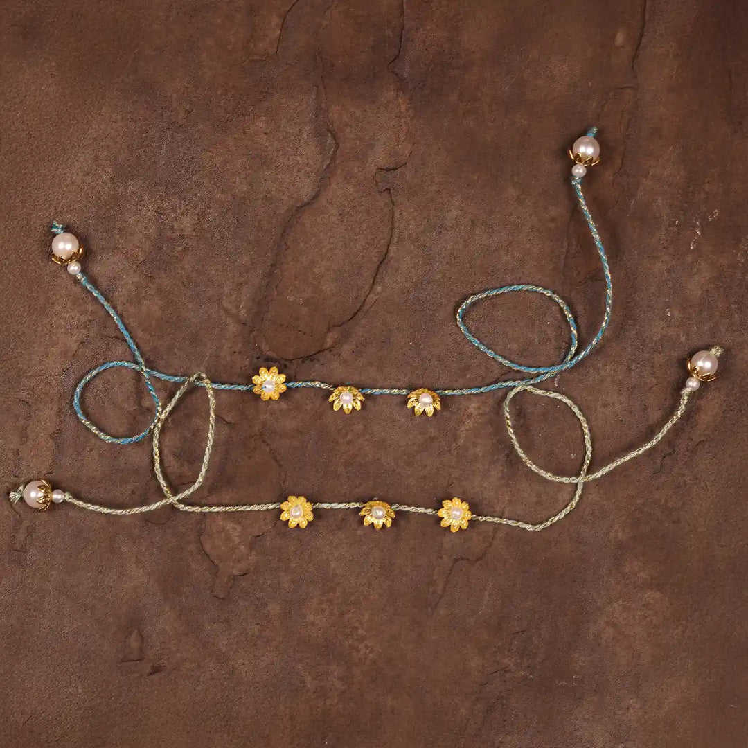 Handmade Golden Flower Rakhi With Roli Chawal Set Of 2 - Flat Lay Back View