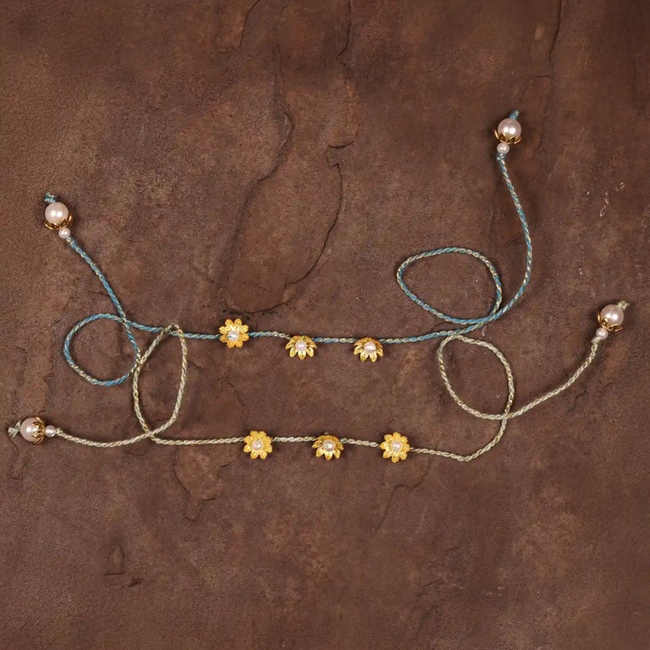 Handmade Golden Flower Rakhi With Roli Chawal Set Of 2 - Flat Lay Back View