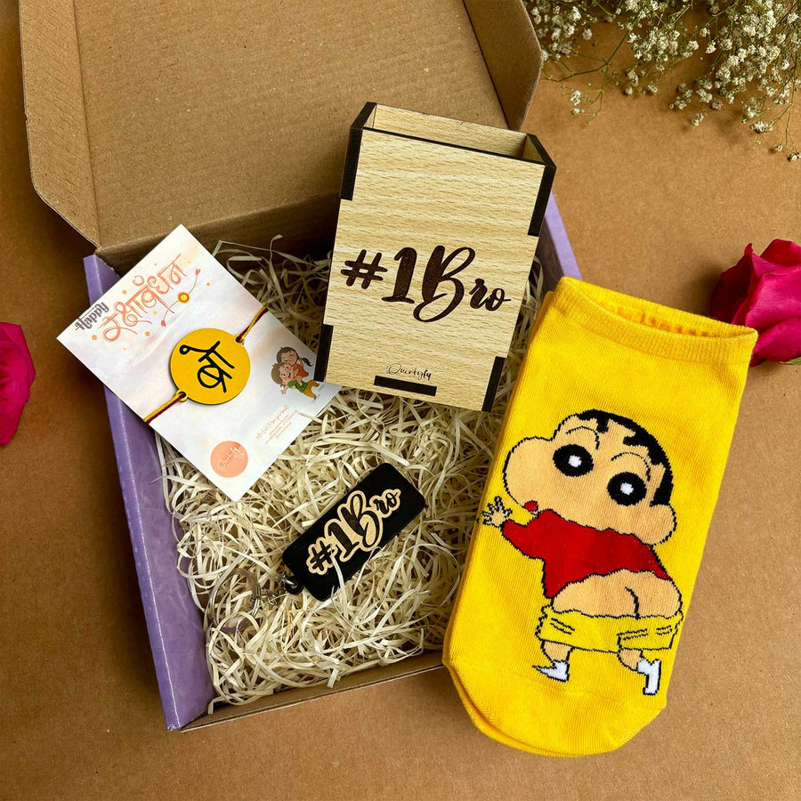 Shinchan Theme Rakhi Hamper For Brother Includes 1 Rakhi 1 Pair Socks 1 Keychain And 1 Pen Holder - Gift Box Contents Layout