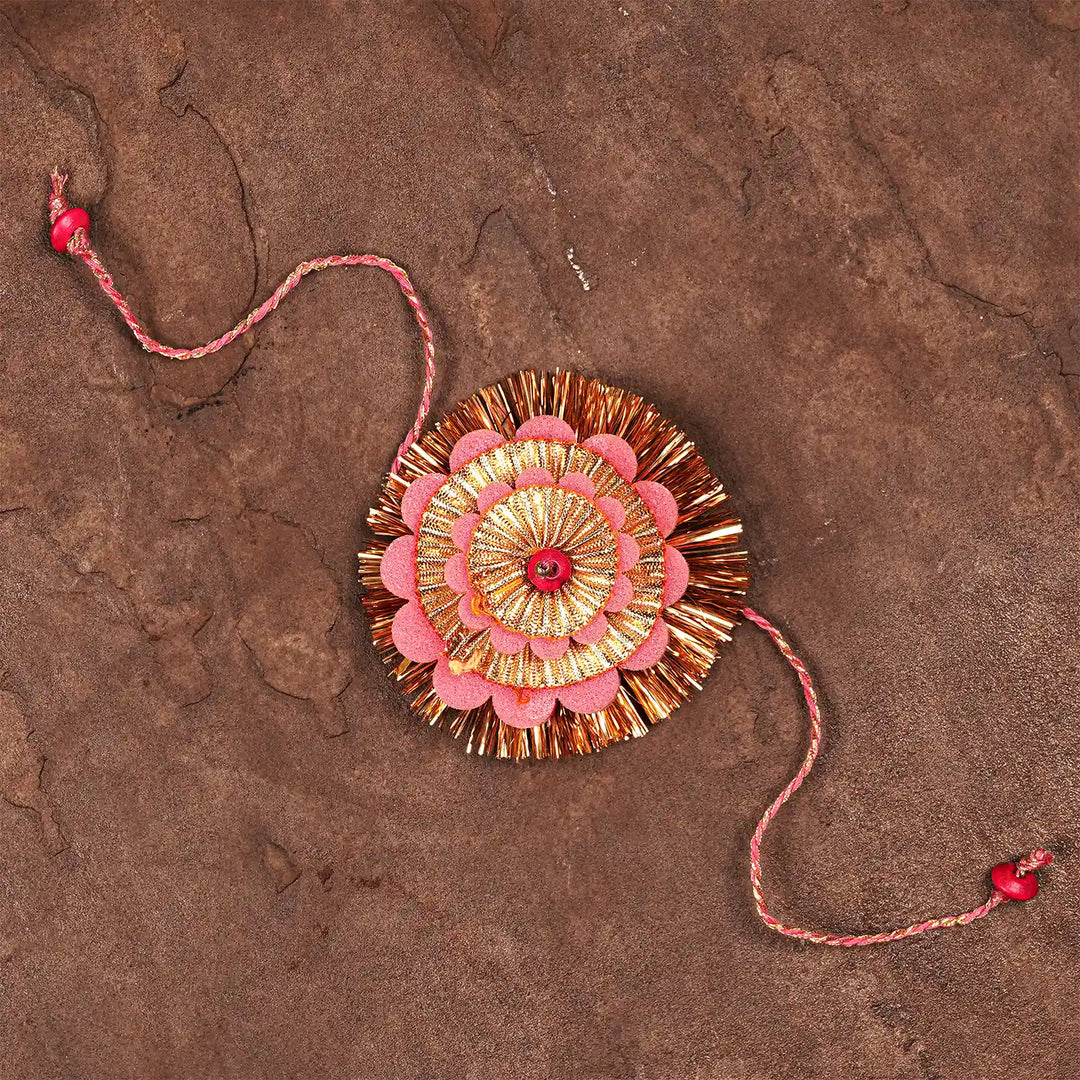 Handmade Layered Pink And Golden Foam Rakhi With Roli Chawal - Top Down View