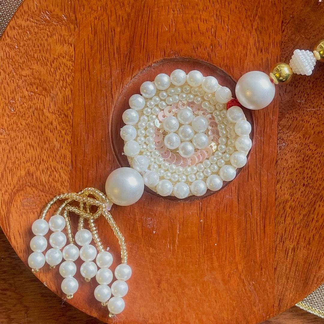 Handmade White Flower Design Pearl And Stone Bhaiya Bhabhi Rakhi - Close-up of Pearl Tassel Detail