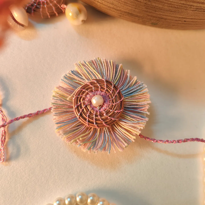 Eco Friendly Handmade Pastel Colour Pine Needle Rakhi With Pouch And Roli Chawal - Close-up of decorative bracelet