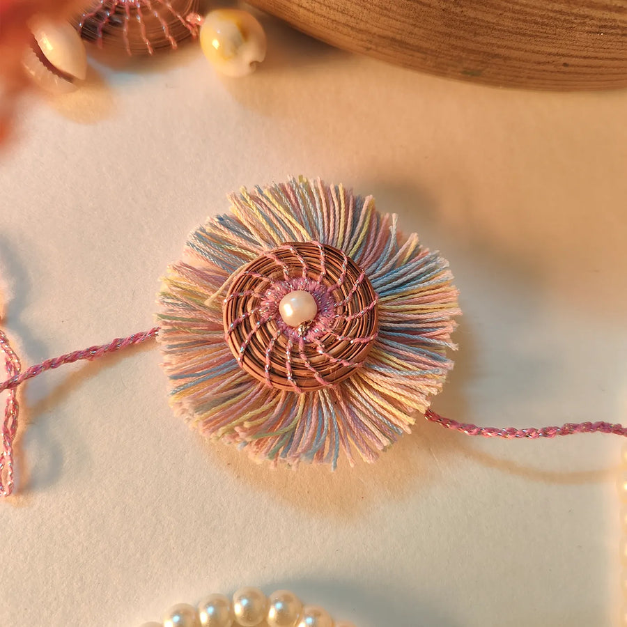 Eco Friendly Handmade Pastel Colour Pine Needle Rakhi With Pouch And Roli Chawal - Close-up of decorative bracelet