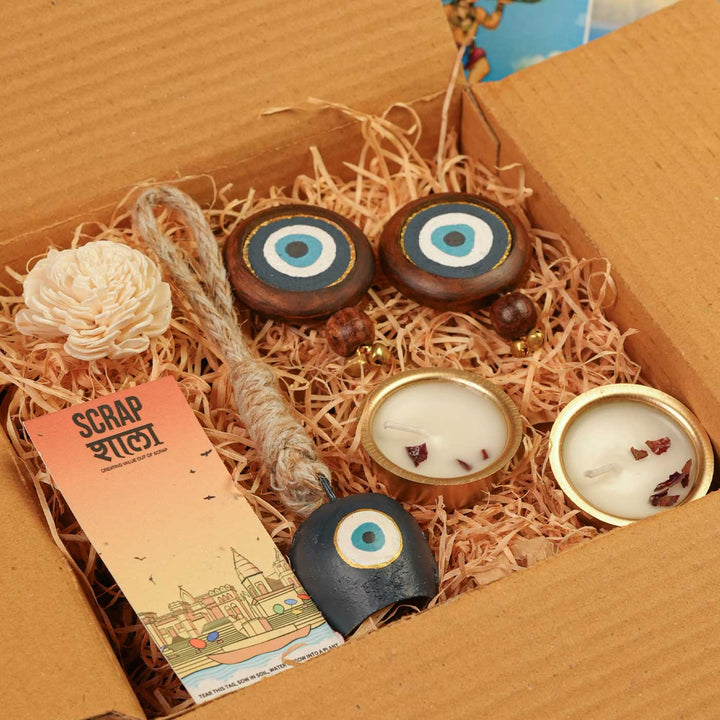 Handmade Nazar Jyoti Gift Hamper | Includes Evil Eye Door Hanging, Evil Eye Bell Hanging, Gold Soy Wax Candles, Seed Card And Outer Box