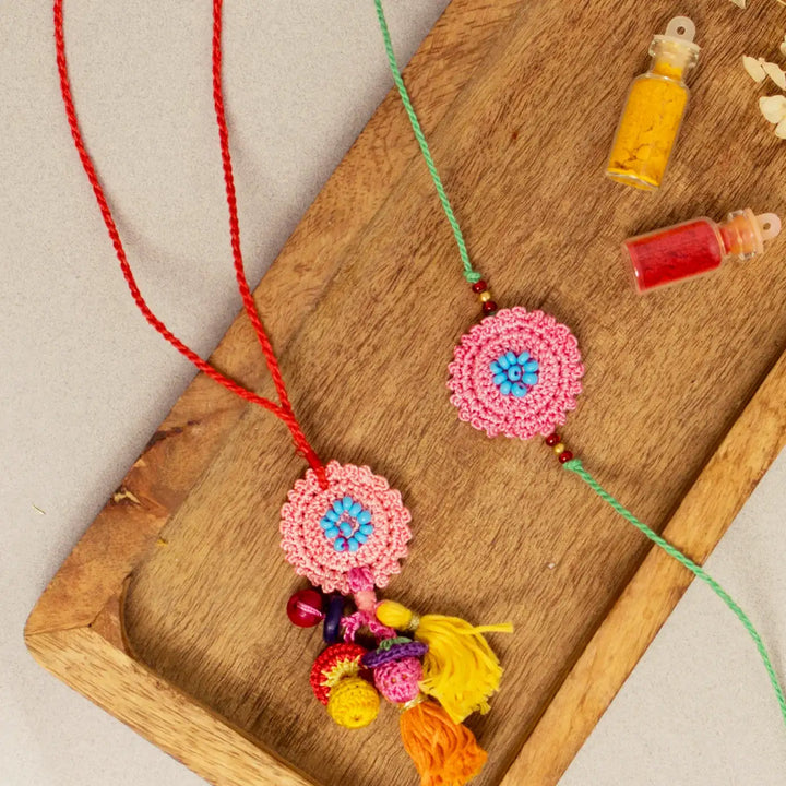 Handmade Crochet Pink Poppy Bhaiya Bhabhi Rakhi With Roli Chawal Set Of 2 - Detailed View with Color Powders