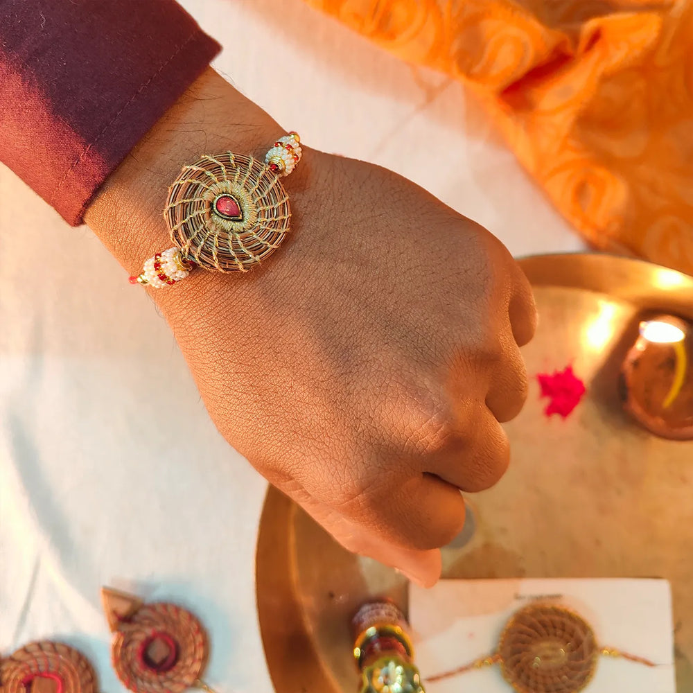 Eco Friendly Handmade Red Stone Pine Needle Rakhi With Pouch And Roli Chawal - On Wrist Styling Shot