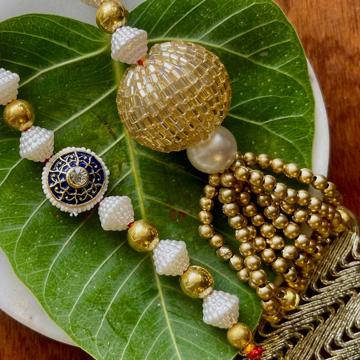 Handmade Blue And Gold Design Pearl And Stone Bhaiya Bhabhi Rakhi - Detailed Bead and Tassel View