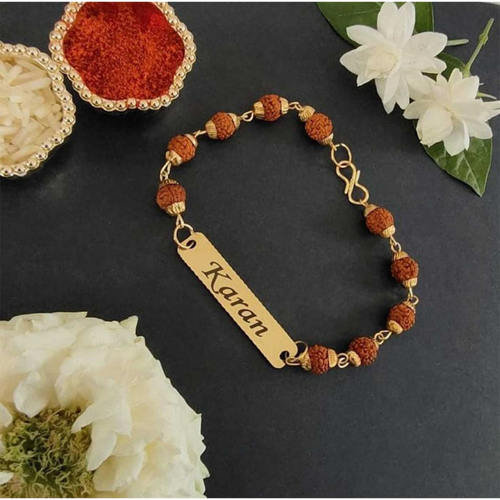 Personalized Handmade Religious Rudraksh Bracelet Rakhi - Flat Lay with Decorative Items