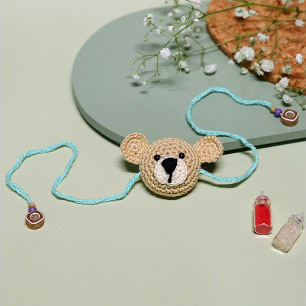 Handmade Crochet Teddy Hug Kids Rakhi With Roli Chawal - Front View with Blue Thread