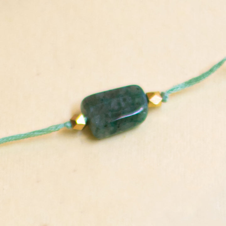Handmade Reusable White Floral Bliss Bhaiya Bhabhi Rakhi With Roli Chawal - Green Bead Bracelet Close-up