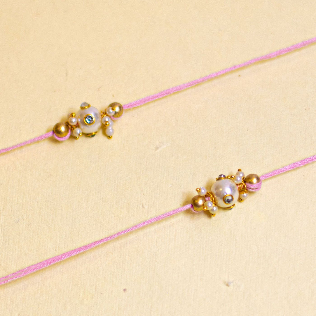 Handmade Basra Pearl Rakhi With Roli Chawal - Detailed close-up of pink bracelets