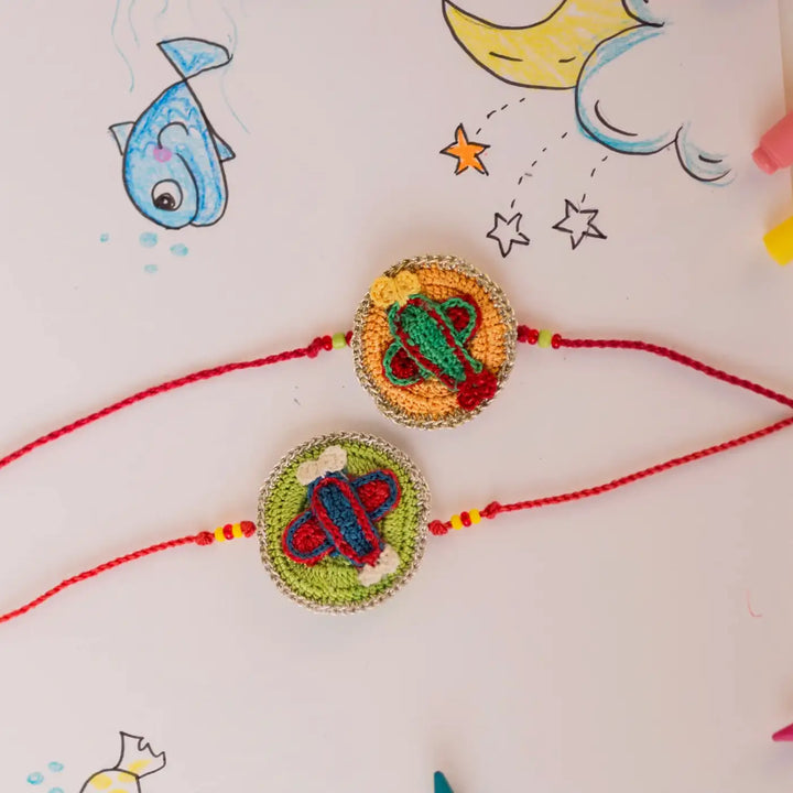 Handmade Crochet Airplane Theme Kids Rakhi With Roli Chawal Set Of 2 - Top View of Paired Charms