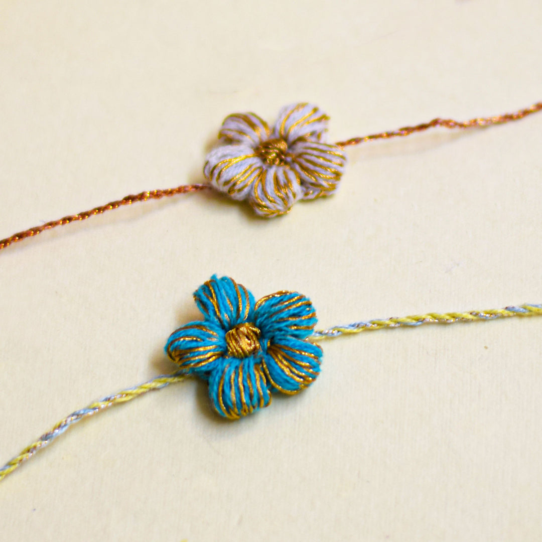 Handmade Crochet Flower And Ghungroo Design Bhaiya Bhabhi Rakhi With Roli Chawal - Close-up of two different flower bracelets