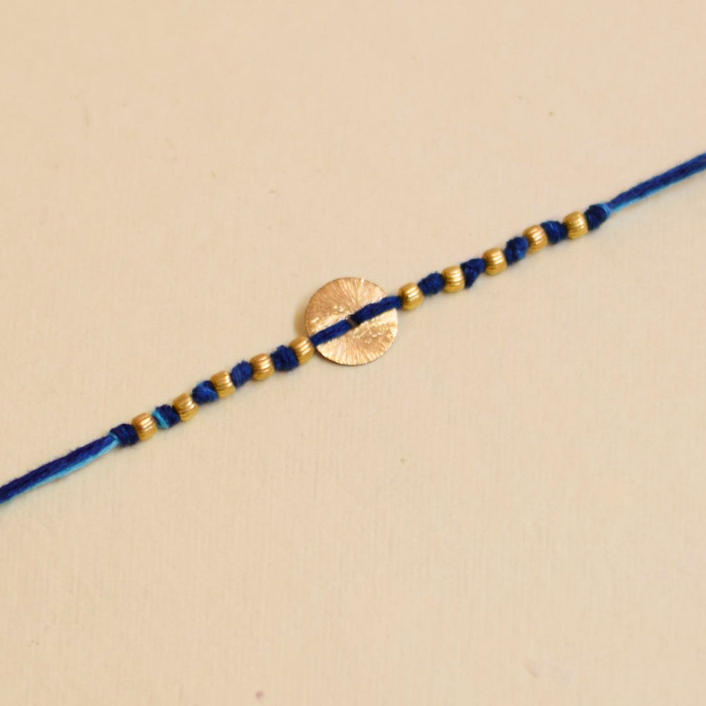 Handmade Swaran Suthra And Pearl Rakhi With Roli Chawal - Close-up Blue Bracelet Detail