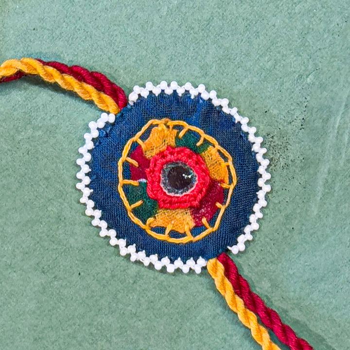 Reusable Mirror And Cotton Rope Rakhi For Brother - Close-up of central embroidered design