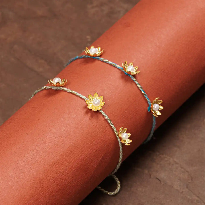 Handmade Golden Flower Rakhi With Roli Chawal Set Of 2 - On Arm Wearing View
