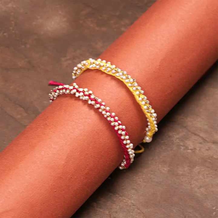Handmade Crochet Pearl Rakhi With Roli Chawal Set Of 2 - Worn on Model Wrist