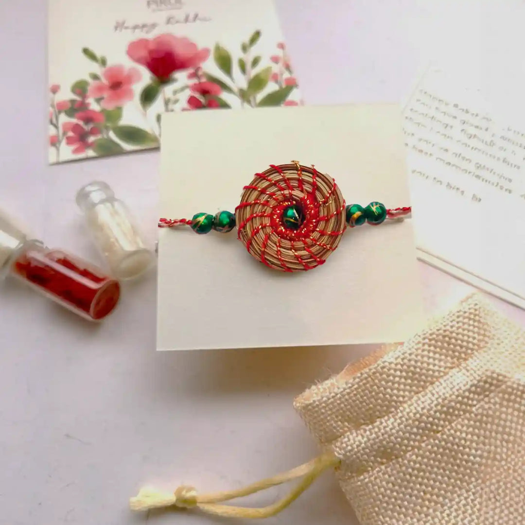 Eco Friendly Handmade Green Breads Pine Needle Rakhi With Pouch And Roli Chawal - In Packaging Display