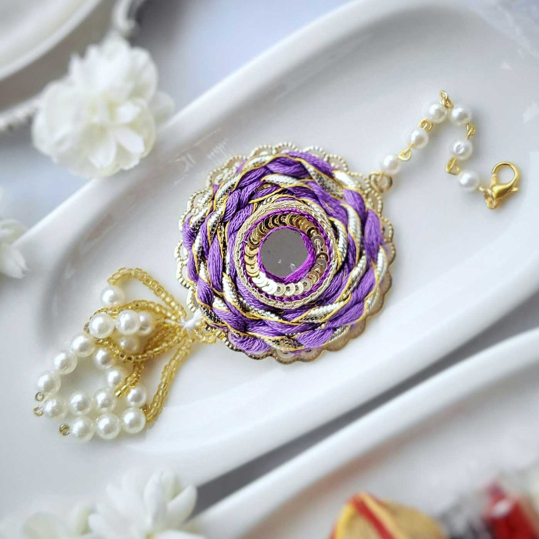 Handmade Mirror Work Braided Rakhi Hamper With Roli Chawal For Bhaiya And Bhabhi - Purple Rakhi Close-up