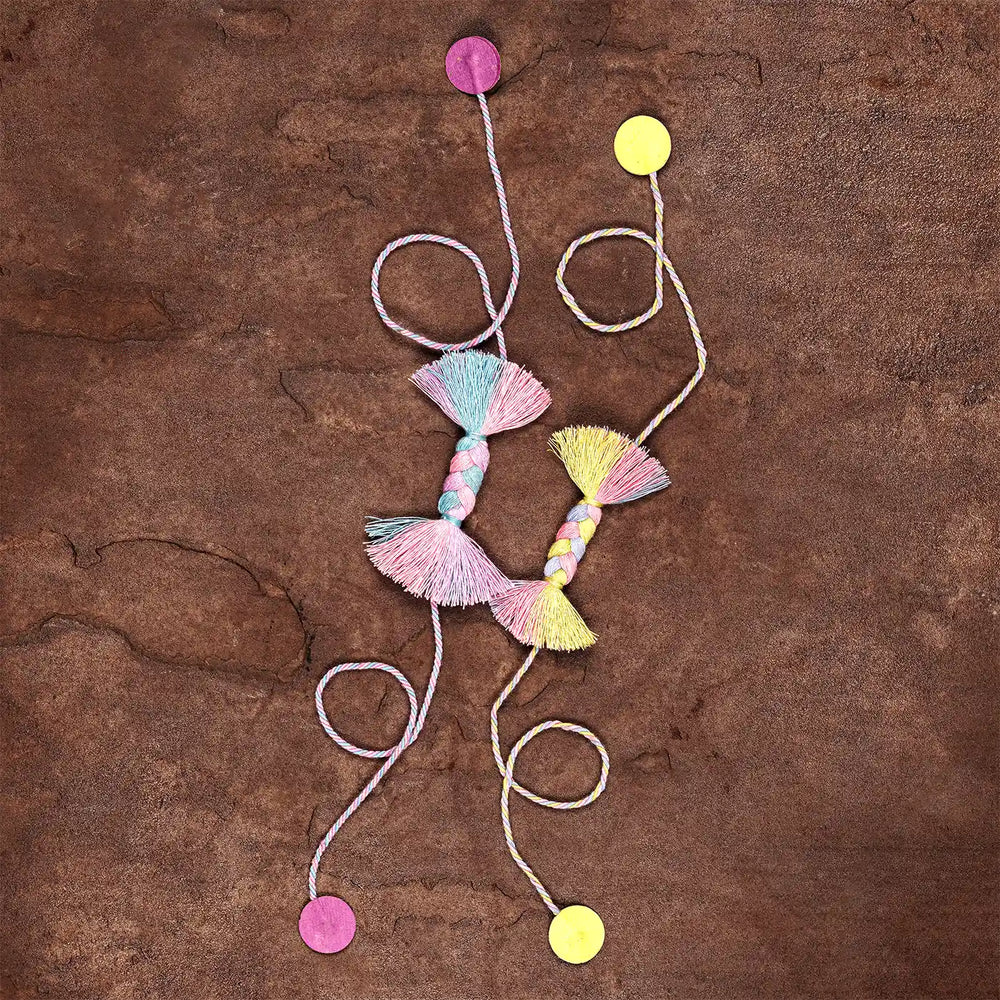 Handmade Braided Candy Rakhi With Roli Chawal Set Of 2 - Flat Lay with Colored Dots