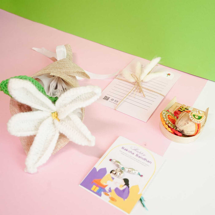 Personalized Handmade Crochet White Lily Rakhi Hamper Includes 1 Crochet Flower 1 Message Card And 1 Rakhi And Roli Chawal - Top View of Wrapped Flower