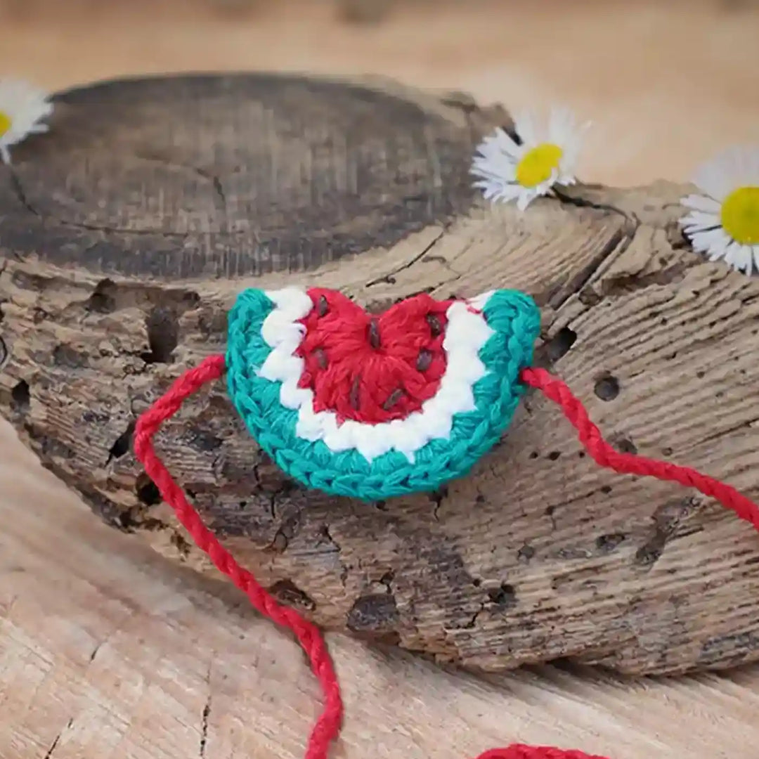 Handmade Crochet Watermelon Theme Kids Rakhi And Toy Combo With Roli Chawal Set Of 2 - Close-up of Watermelon Crochet Piece with Tassels