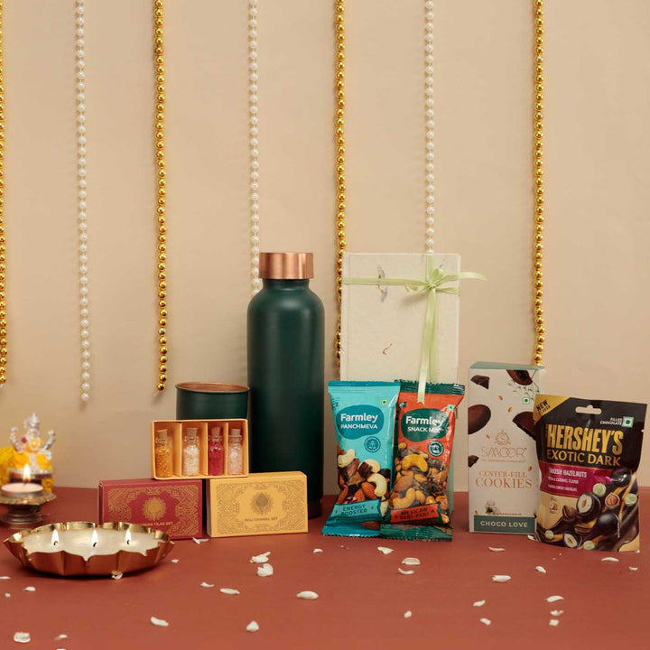 Handmade Umang Gift Hamper | Includes 1 Bottle, 2 Glasses, 1 Chocolate, 1 Chocolate Bar, 2 Dry Fruit, 1 Diary, 1 Candle, 1 X Roli Chawal, 1 Pooja Set,1 Card And 1Box