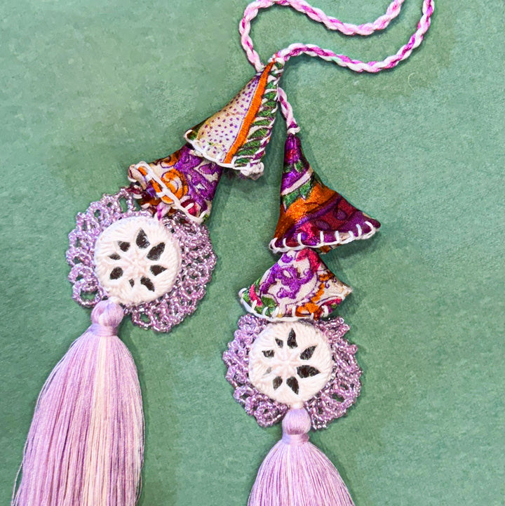 Handmade Reusable Lavender Mirror And Jhumki Rakhi For Bhaiya And Bhabhi - Close-up of Pendant and Tassels