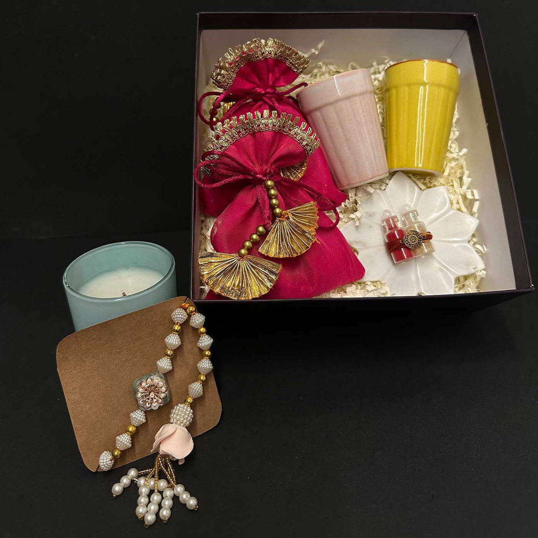 Handmade Riwaayat Duo Rakhi Hamper Includes 1 Marble Lotus 2 Kulhads 1 Candle 1 Kum Kum Chawal 1 Dry Fruit Potli And 1 Set Bhaiya Bhabhi Rakhi - Gift Box Angled View