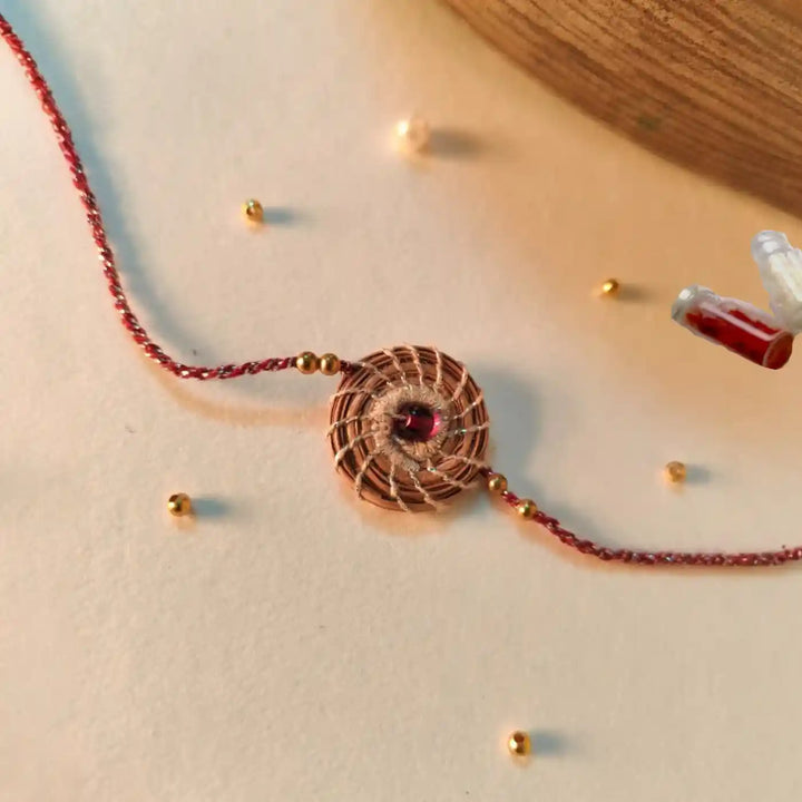 Eco Friendly Handmade Silver And Red Pine Needle Rakhi With Pouch And Roli Chawal - Close-up Detail View