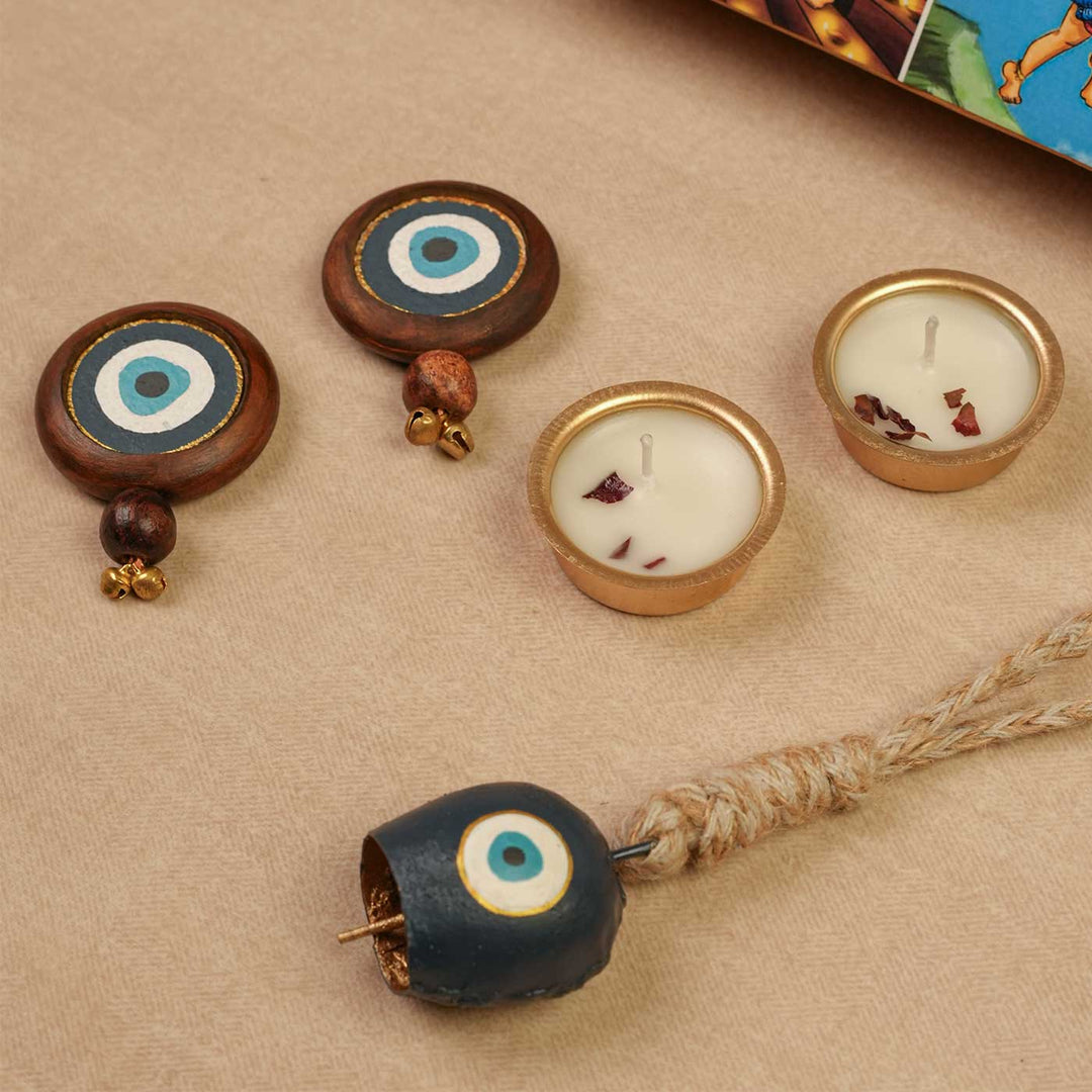 Handmade Nazar Jyoti Gift Hamper | Includes Evil Eye Door Hanging, Evil Eye Bell Hanging, Gold Soy Wax Candles, Seed Card And Outer Box