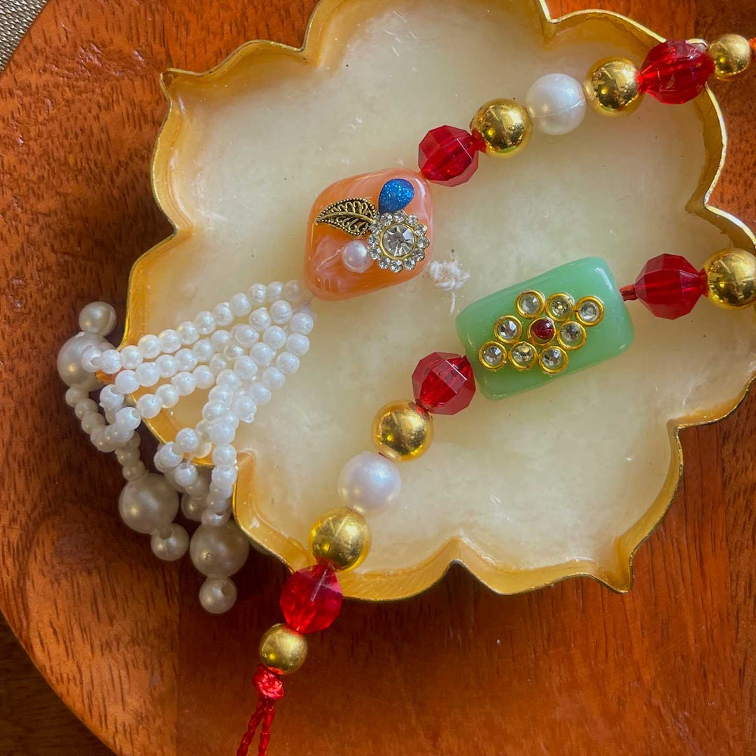 Handmade Green And Pink Design Pearl And Stone Bhaiya Bhabhi Rakhi - Close-up of Bead and Tassel