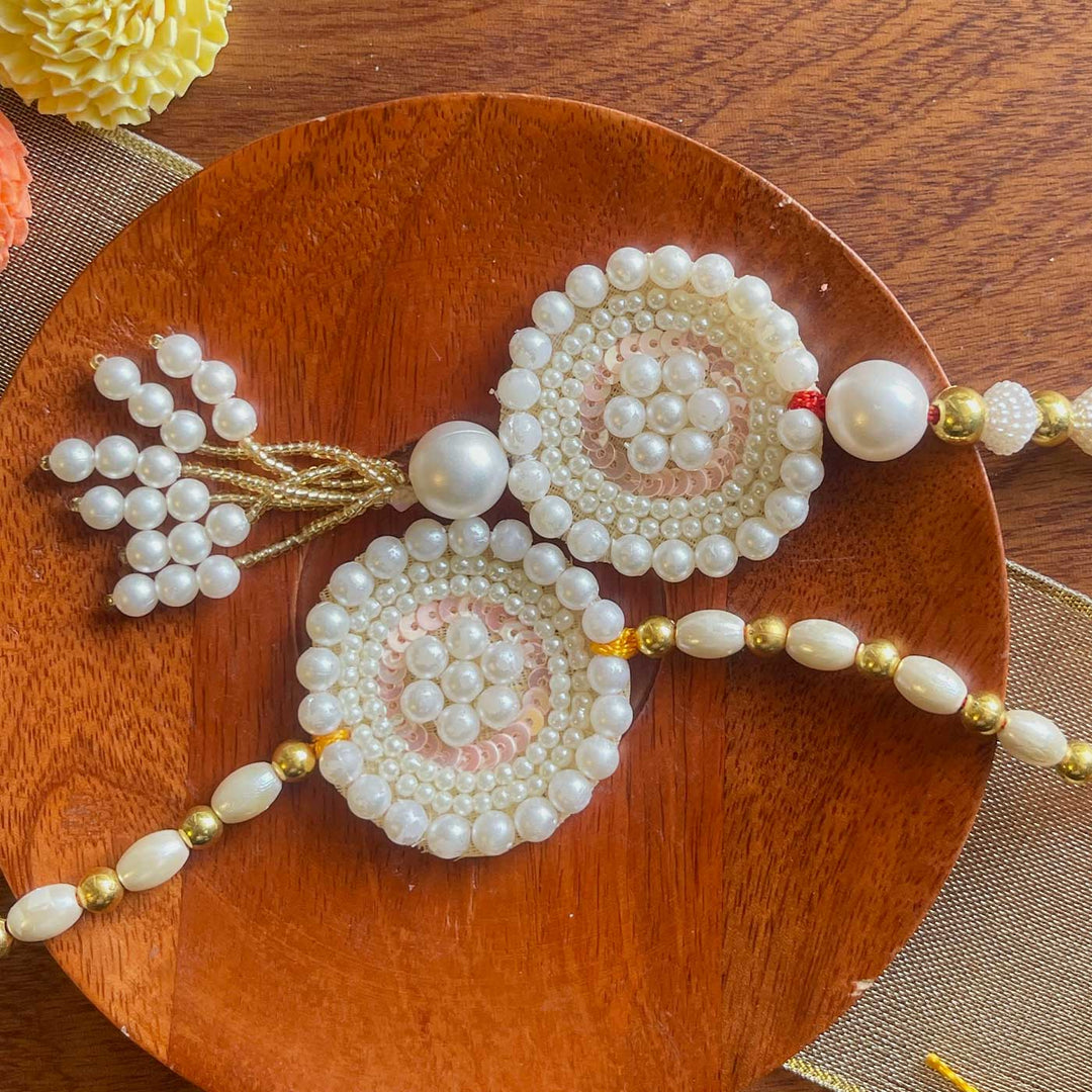 Handmade White Flower Design Pearl And Stone Bhaiya Bhabhi Rakhi - Full Product Display Slight Angle