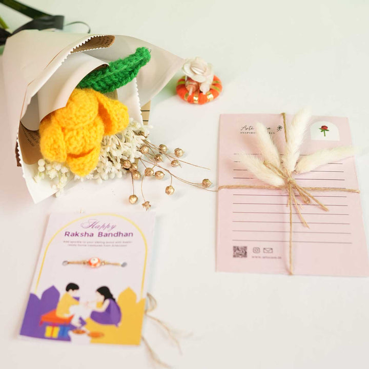 Personalized Handmade Crochet Tulip Dried Bunch Rakhi Hamper Includes 1 Crochet Flower Bunch 1 Message Card And 1 Rakhi And Roli Chawal - Flat Lay with Accessories
