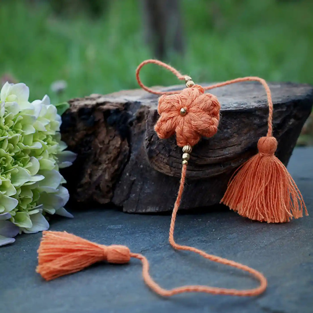 Handmade Crochet Blue Flower Rakhi With Roli Chawal - Orange Threaded Flower Close-up