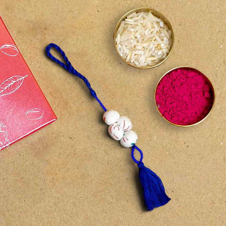 Handmade Shweth Potli Upcycled Fabric Lumba Rakhi for Bhabhi With Roli Chawal