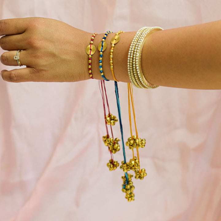 Handmade Swarn Sutra Ghungroo Bhaiya Bhabhi Rakhi With Roli Chawal - Model Wrist Shot with Bracelets