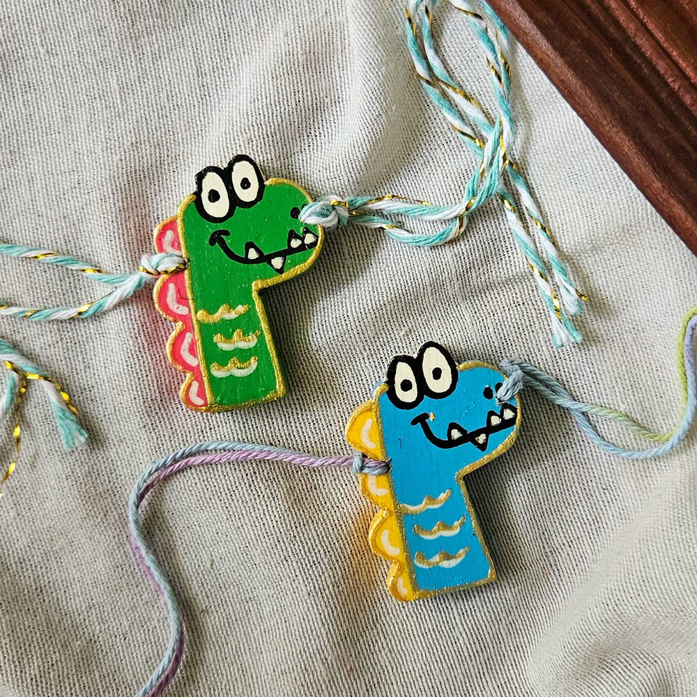 Handpainted Quirky Wooden Rakhi With Roli Chawal 17 - Two Dino Bracelets Side by Side
