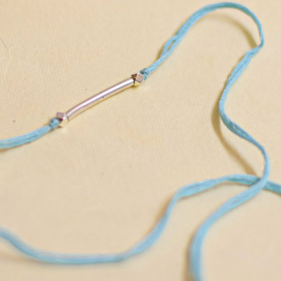 Handmade Stake Board Shoe And Pearl Design Rakhi With Roli Chawal - Blue string bracelet bar detail
