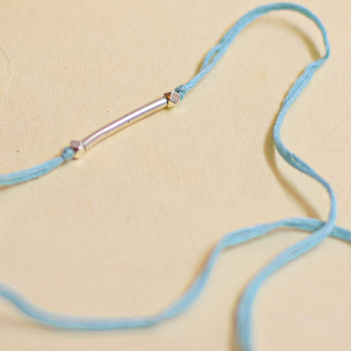 Handmade Stake Board Shoe And Pearl Design Rakhi With Roli Chawal - Blue string bracelet bar detail