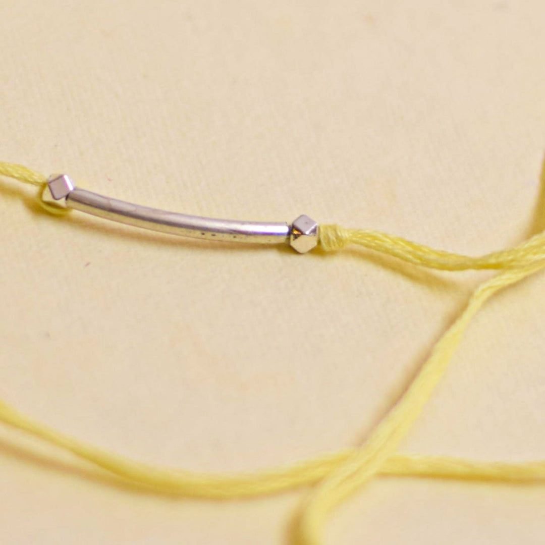 Handmade Stake Board Shoe And Pearl Design Rakhi With Roli Chawal - Yellow string bracelet bar detail