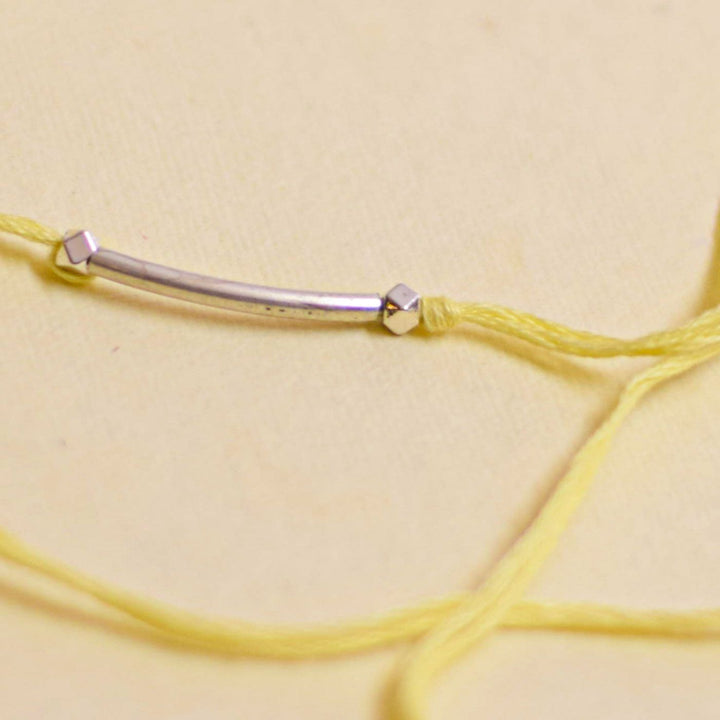 Handmade Stake Board Shoe And Pearl Design Rakhi With Roli Chawal - Yellow string bracelet bar detail