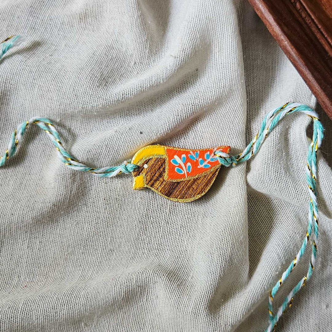 Handpainted Quirky Wooden Rakhi With Roli Chawal 4 New - Close-up with Extended Threads Visible